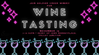 Neon-style flyer for a Soldier Creek Winery wine tasting event. The words 'Join Soldier Creek Winery for Wine Tasting' are displayed in large white and pink neon letters. Below, it reads 'November 16, 11-12:30 PM | Heart of Iowa Marketplace, Valley Junction' in pink text. The design features glowing neon wine glasses along the bottom and sparkling pink stars on either side of the text on a black background.