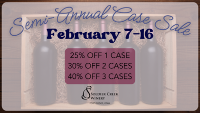 Promotional graphic for Soldier Creek Winery's Semi-Annual Case Sale, running February 7–16. The background features wine bottles in a wooden crate lined with straw. Text highlights discounts: 25% off 1 case, 30% off 2 cases, and 40% off 3 cases. The Soldier Creek Winery logo and location, Fort Dodge, Iowa, are displayed at the bottom.