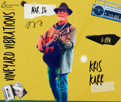 A promotional poster for Vineyard Vibrations at Soldier Creek Winery, featuring Kris Karr performing on March 14 from 6-8 PM. The poster has a bright yellow background with a vintage music theme, including cassette tapes and a boombox illustration. Kris Karr is depicted playing an acoustic guitar, wearing a fedora and a jacket, with a smile on his face.