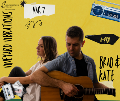 Promotional graphic for 'Vineyard Vibrations' at Soldier Creek Winery on March 7 from 6–8 PM. The background is yellow with a collage-style design featuring cassette tapes, a boombox, and abstract black and yellow grid patterns. The central image features musical duo Brad & Kate, with Kate sitting cross-legged, leaning back on Brad, who is playing an acoustic guitar. The event details, including date and time, are displayed in bold black text, with 'Vineyard Vibrations' written in large, hand-drawn font at the top. The Soldier Creek Winery logo is positioned in the bottom left corner.